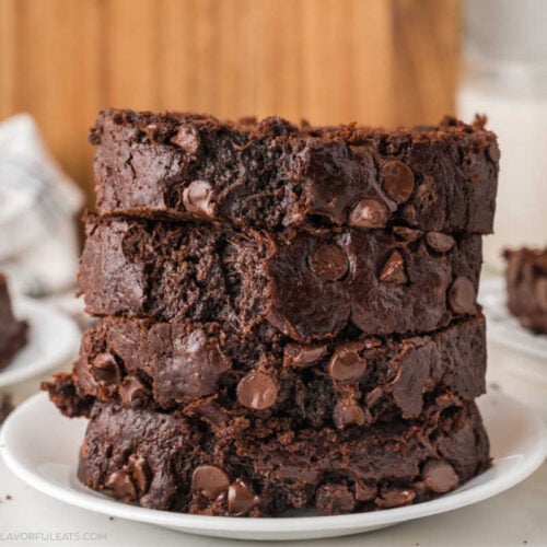 Double Chocolate Zucchini Bread sliced and stacked on a plate.