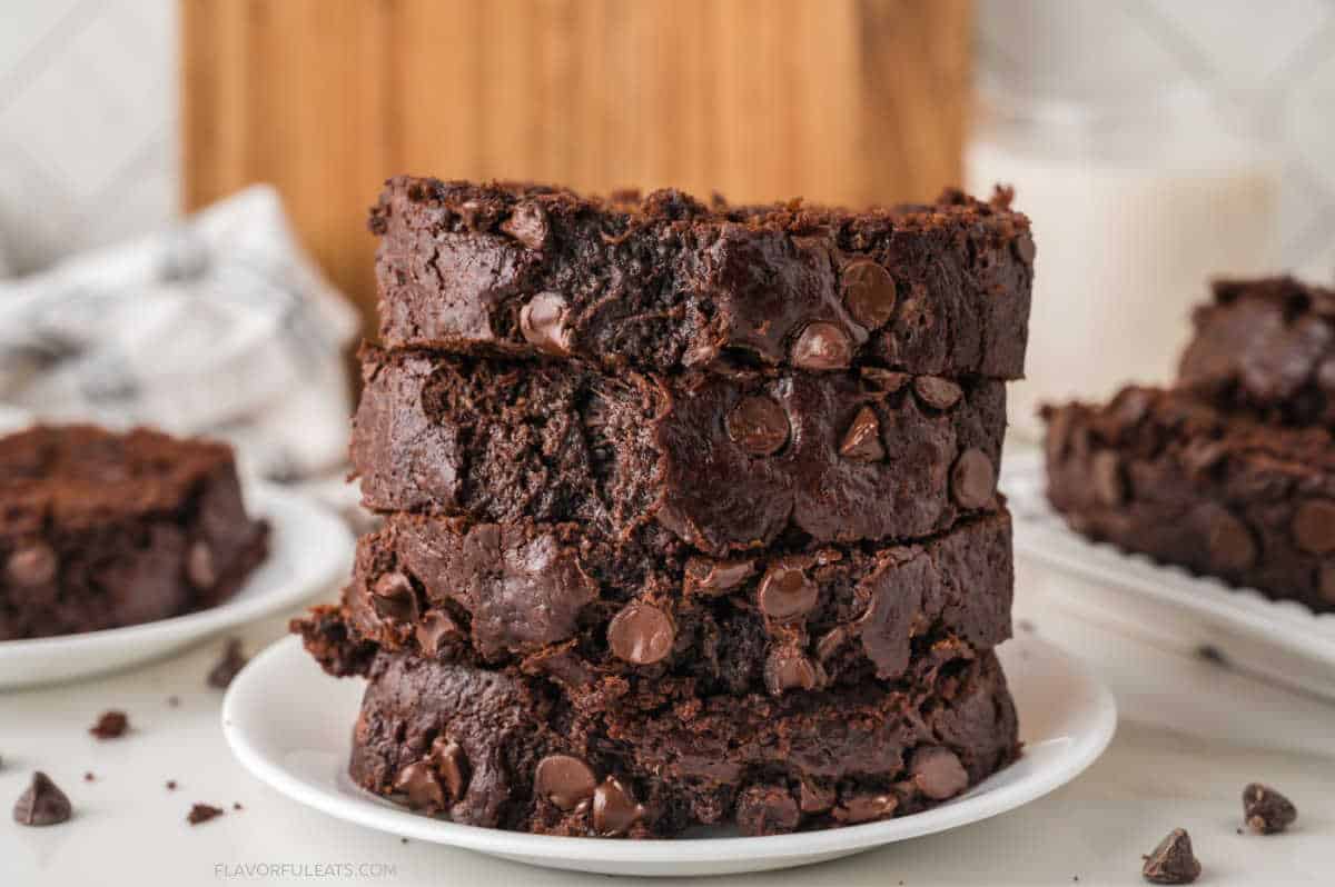 Double Chocolate Zucchini Bread sliced and stacked on a plate.