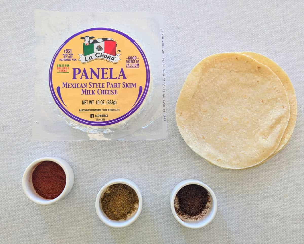 A photo of the ingredients needed to make Panela Cheese Tacos, panela cheese, tortillas, and spices.