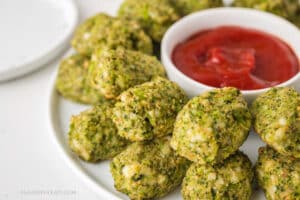 Baked Mozzarella Broccoli Tots on a serving platter with ketchup.