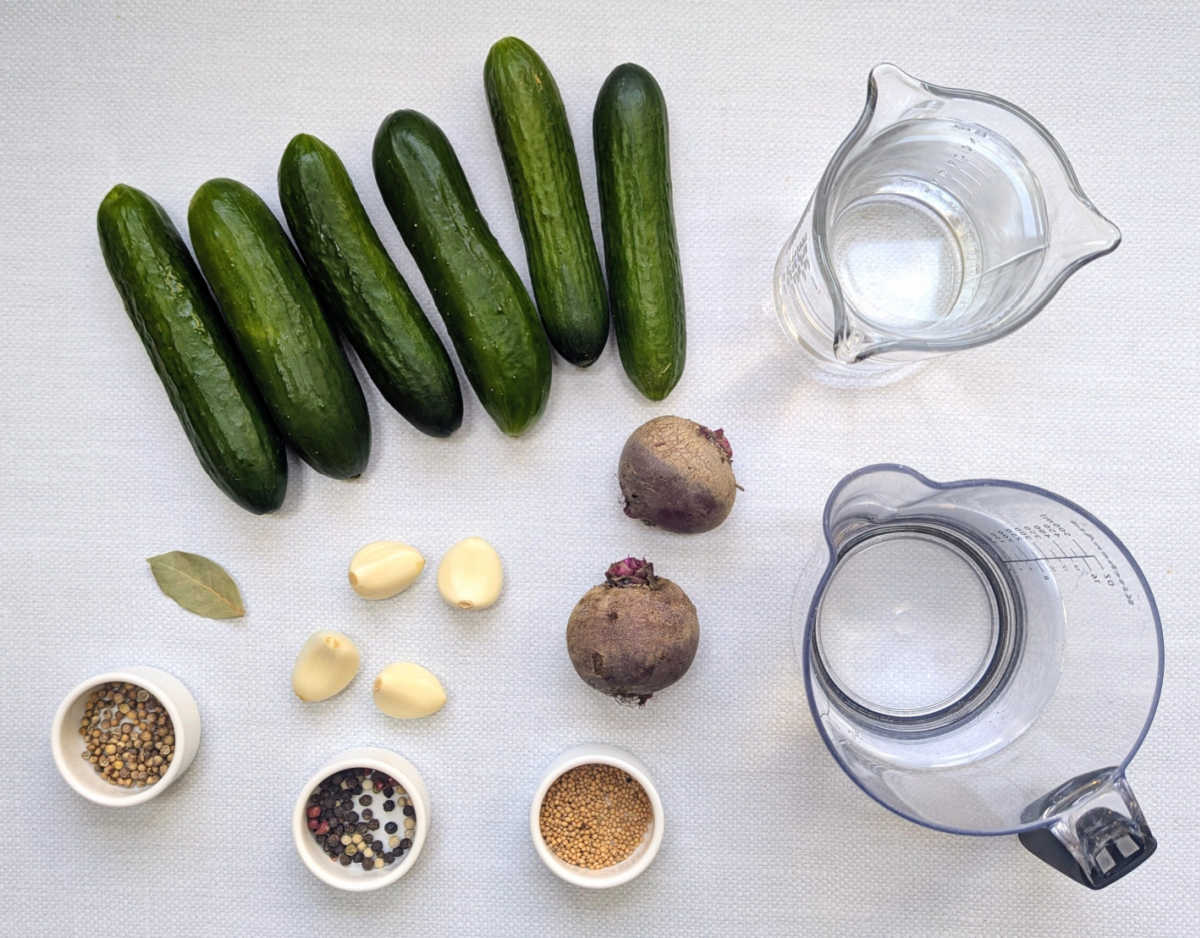 The ingredients needed to make Pink Pickled Cucumbers.