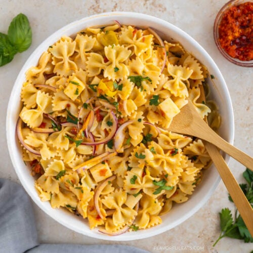 Calabrian Chili Pasta Salad in a serving bowl with serving spoons.