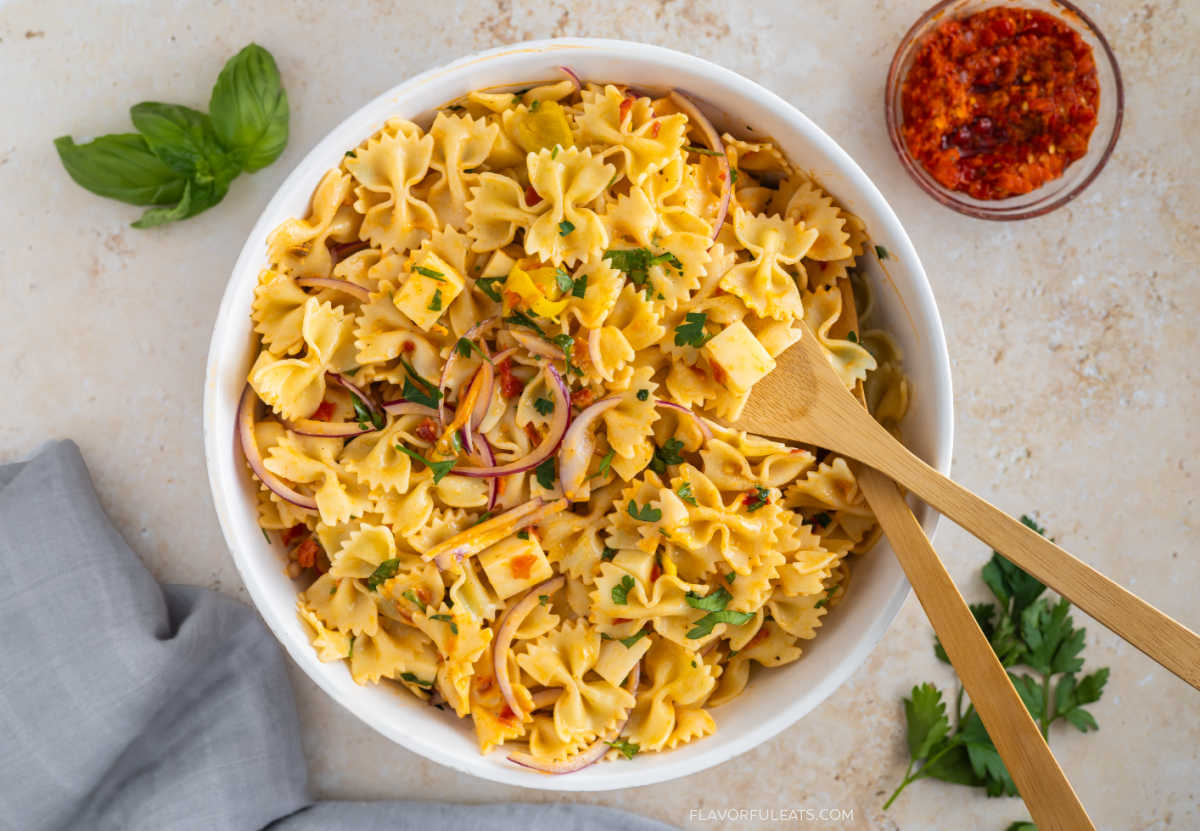 Calabrian Chili Pasta Salad in a serving bowl with serving spoons.