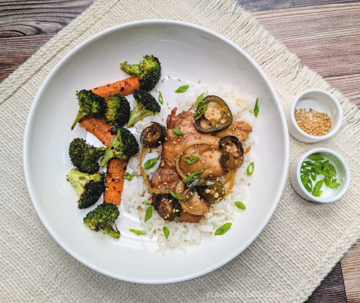 Slow Cooker Soy Jalapeno Chicken plated over rice with a side of vegetables.