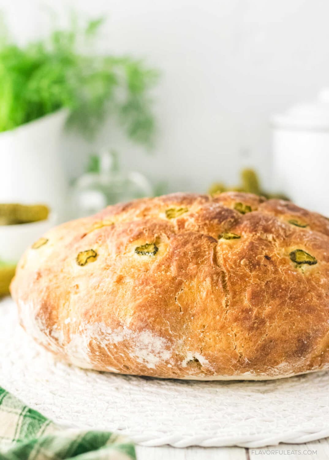 A loaf of No-Knead Dutch Oven Pickle Bread before it's sliced.