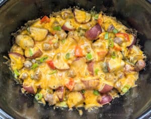 Slow Cooker Sausage Breakfast Hash in the slow cooker with cheese melted.