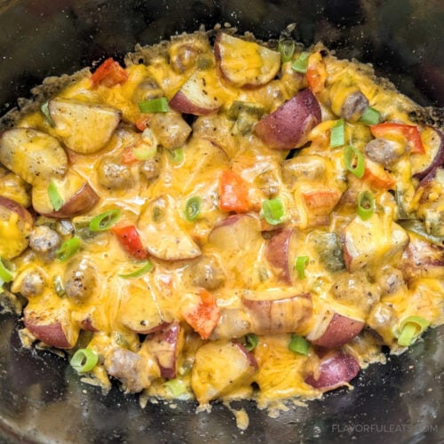 Slow Cooker Sausage Breakfast Hash in the slow cooker with cheese melted.