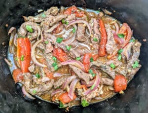 Slow Cooker Lomo Saltado in a slow cooker.