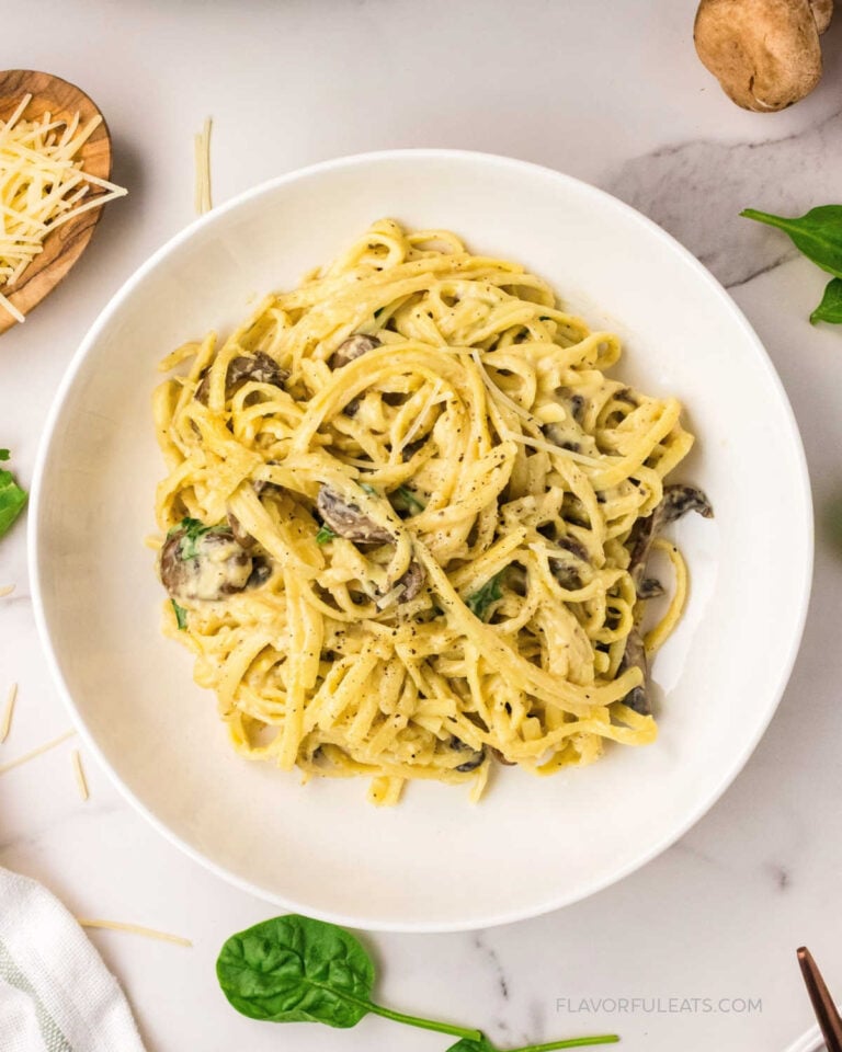 One-Pan Creamy Mushroom & Spinach Pasta plated with Parmesan cheese.
