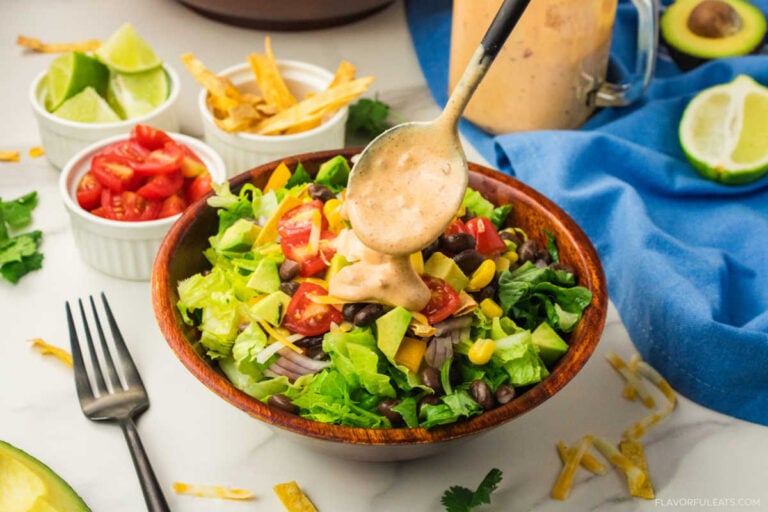 Creamy Chipotle Sauce & Dressing being spooned on a salad.
