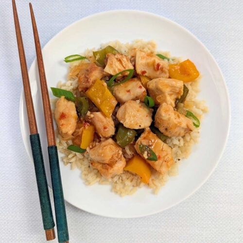 Slow Cooker Sweet Chili Chicken plated with chopsticks.